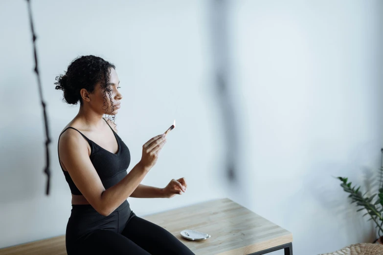 a woman sitting on a table using a cell phone, skincare, profile image, pixvy, multiple stories