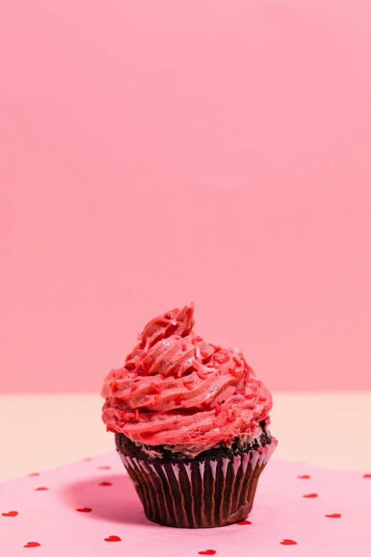 a cupcake sitting on top of a pink table, profile image, gooey skin, detailed product shot, red