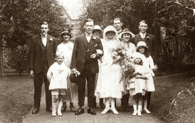 a black and white photo of a wedding party, a black and white photo, by Elsie Henderson, art nouveau, retro stylised, children's, with a whitish, beaten