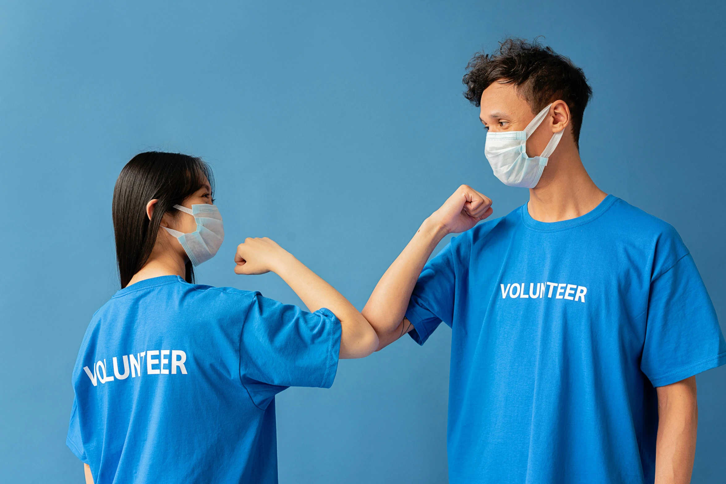 a man and a woman wearing face masks, pexels contest winner, blue uniform, reaching out to each other, avatar image, wearing shirts