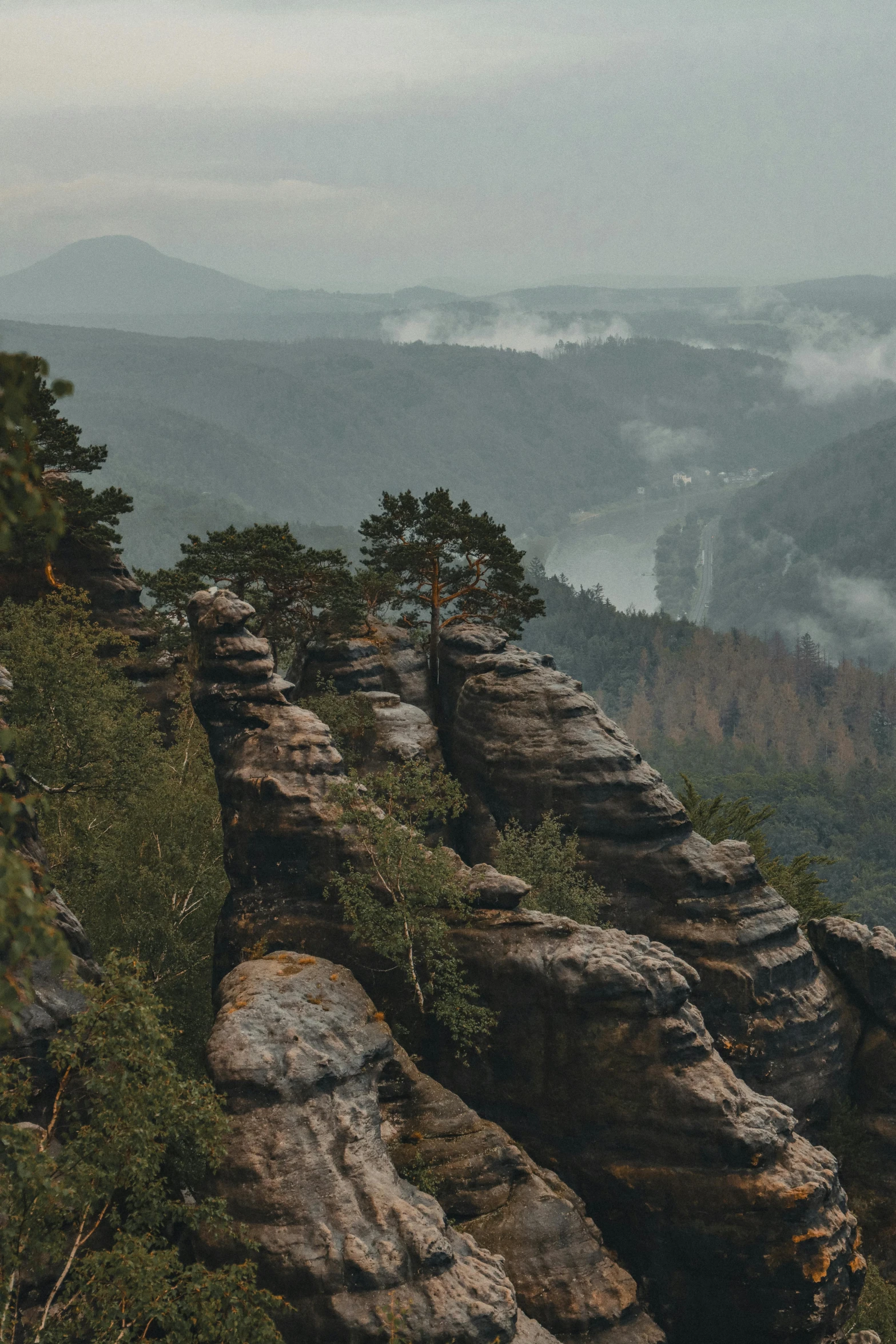 a group of people standing on top of a mountain, by Adam Marczyński, pexels contest winner, german romanticism, river and trees and hills, jagged rocks, panoramic view, stacked image