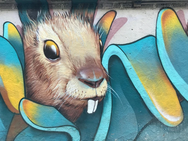 a painting of a rabbit on the side of a building, graffiti art, by NEVERCREW, pexels contest winner, street art, anthropomorphic furry otter, detail face, squirrel, wall mural