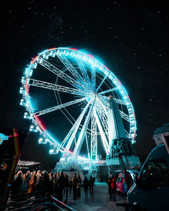 people standing in front of a ferris wheel at night, the sky is all that illuminates, spacestation, photo of zurich, festivals