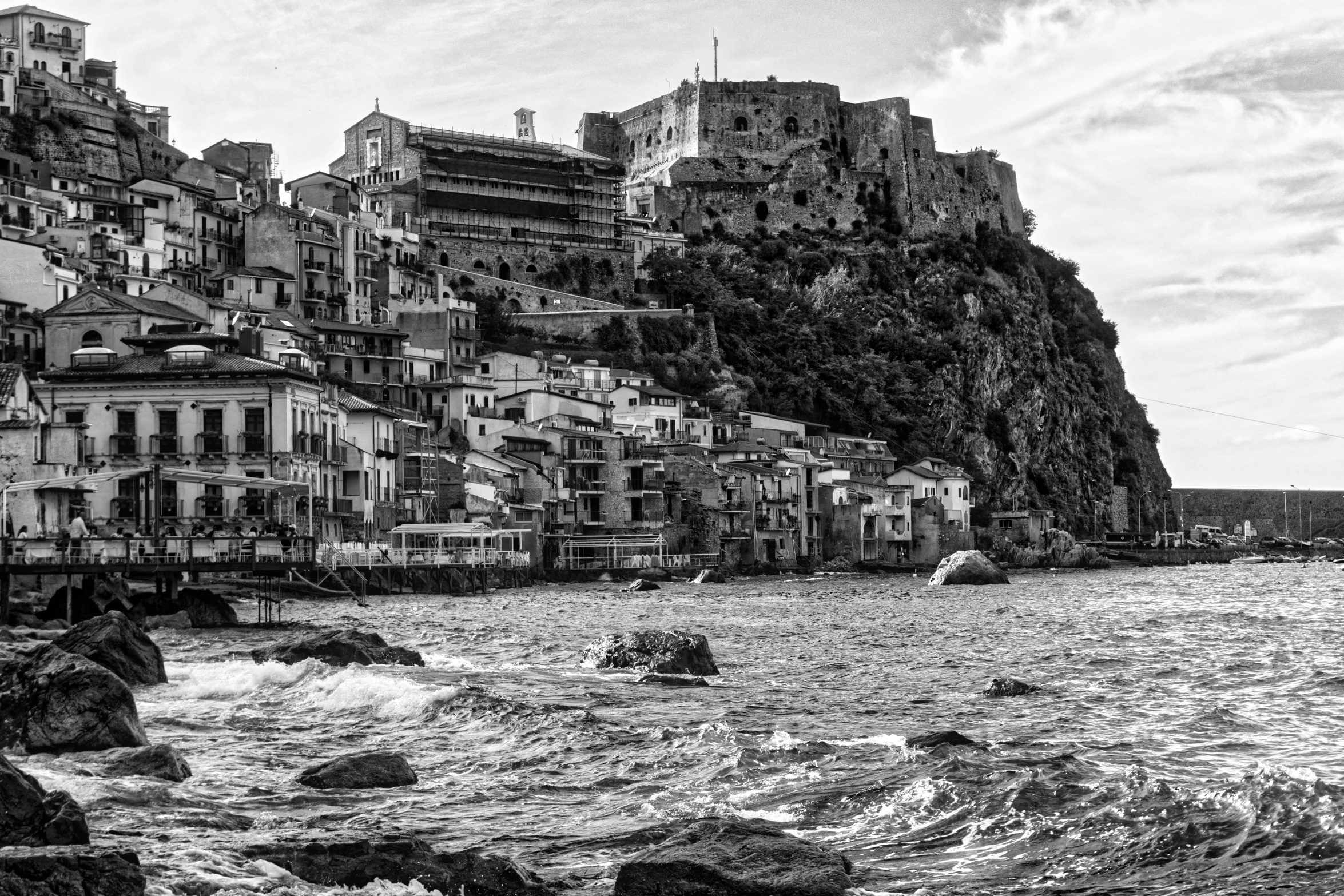 a black and white photo of a town by the water, by Patrick Pietropoli, castle on the mountain, piroca, high quality image, lowres