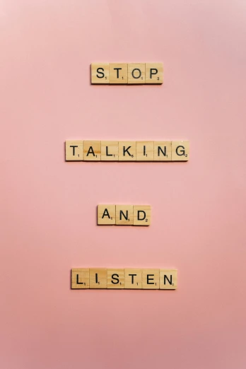 a sign that says stop talking and listen, a poster, by Andries Stock, trending on pexels, pink pastel, tan, addiction, intelligence