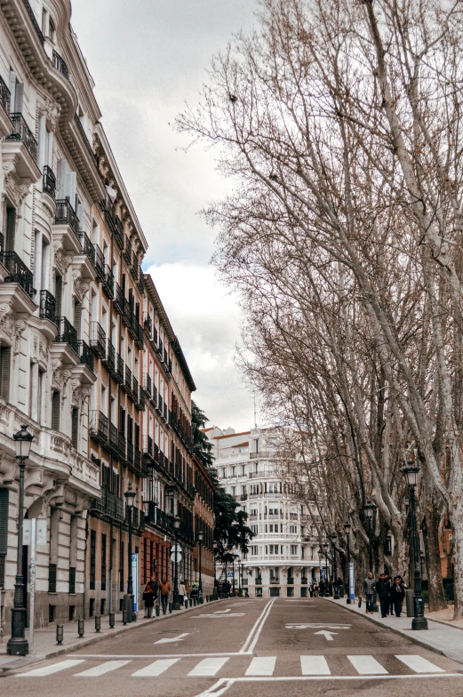 a red fire hydrant sitting on the side of a road, inspired by Joaquín Torres García, neoclassicism, massive trees with warm windows, white marble buildings, gif, market