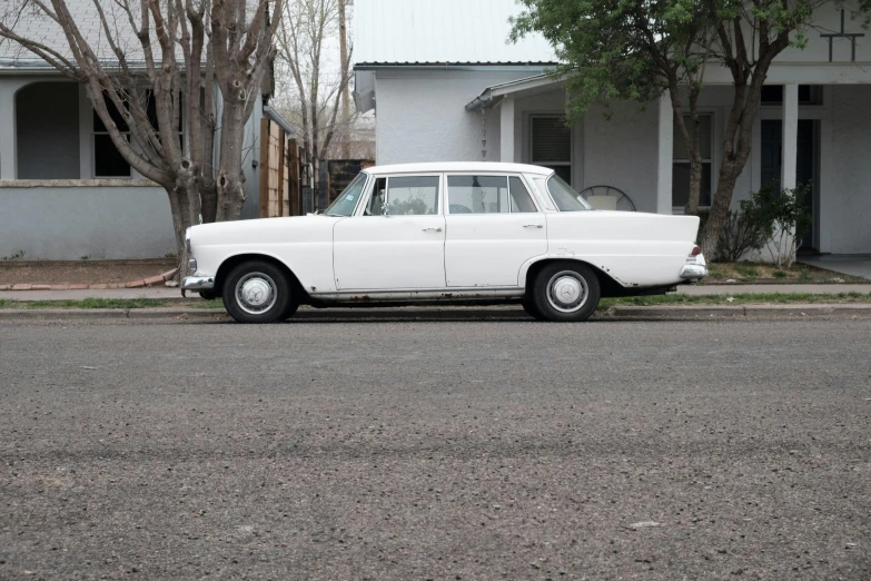 a white car parked on the side of the road, pexels contest winner, photorealism, circa 1958, square, mercedez benz, albuquerque