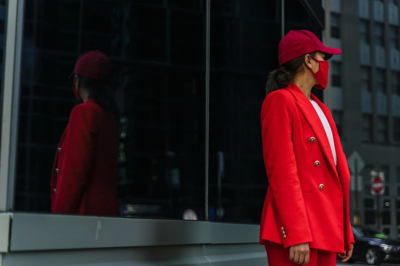 a woman in a red suit and a red hat, pexels contest winner, people are wearing masks, highly reflective, wearing a blazer, outlive streetwear collection