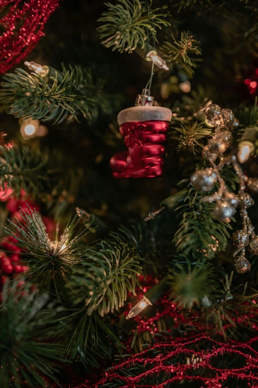 a close up of a christmas tree with ornaments, crimson themed, thumbnail, cosy, small