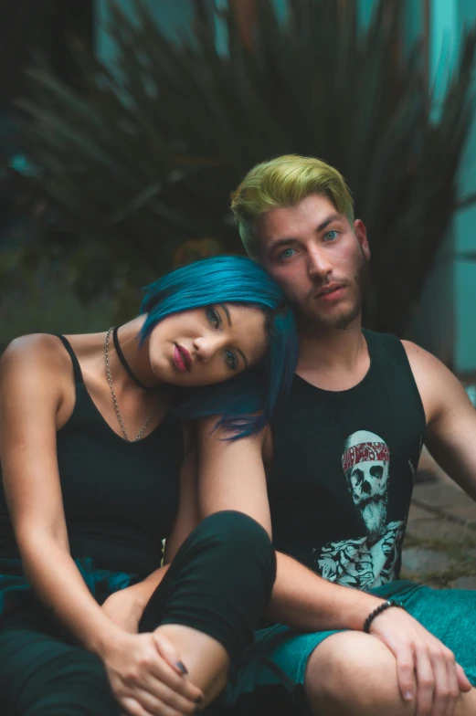 a man and a woman sitting next to each other, a portrait, inspired by Elsa Bleda, trending on pexels, blue hair, hot topic, lgbt, solid colors