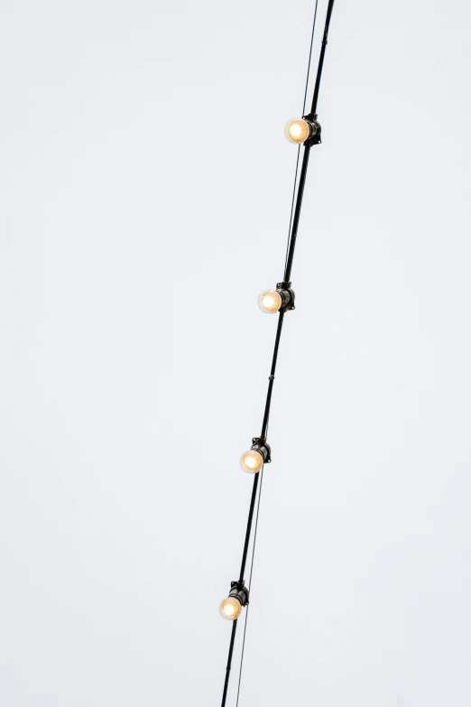 a close up of a lamp on a pole, by Nina Hamnett, conceptual art, pearl necklace, plain background, - 6, leds