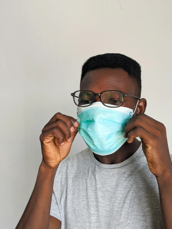 a man wearing glasses and a face mask, an album cover, pexels, emmanuel shiru, surgical supplies, 2070, male teenager