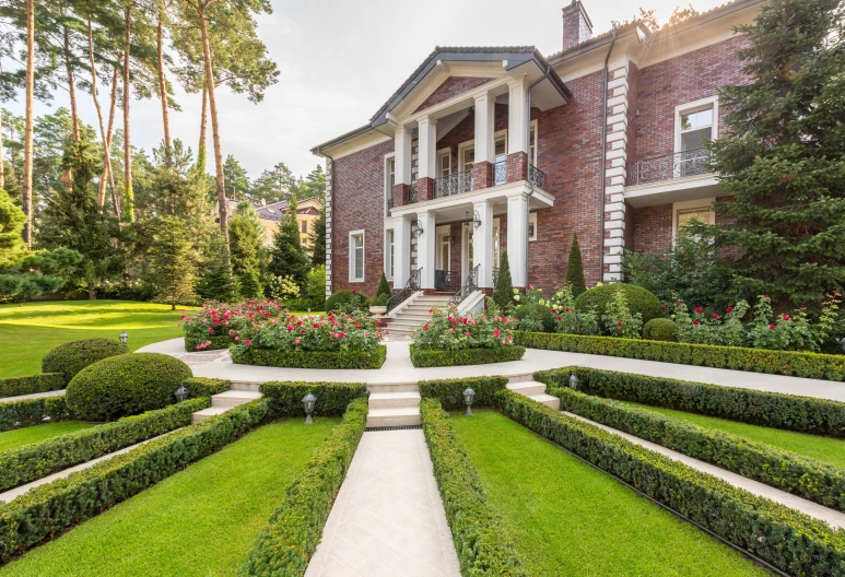 a large house in the middle of a lush green yard, inspired by Edward Willis Redfield, pexels contest winner, neoclassicism, gardens with flower beds, maxim sukharev, neotraditional modern, staggered terraces