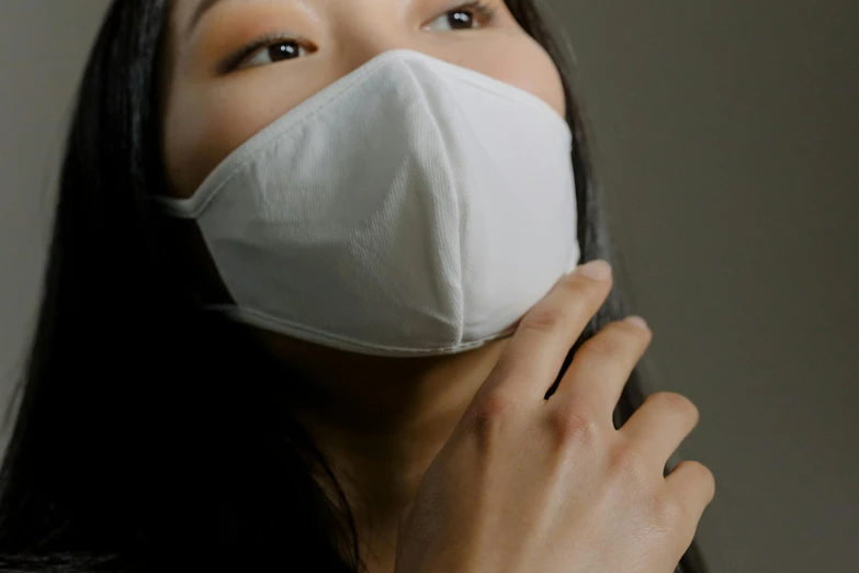 a close up of a person wearing a face mask, trending on pexels, sōsaku hanga, gemma chan, on grey background, to protect us, frosty breath