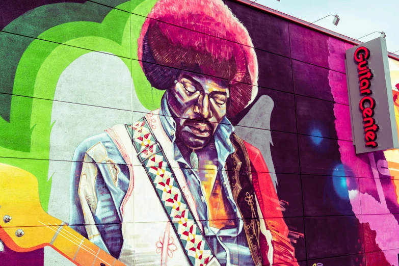 a mural of a man with a guitar on the side of a building, pexels contest winner, funk art, jimi hendrix, 🎨🖌️, george clinton, psychedelic colorization