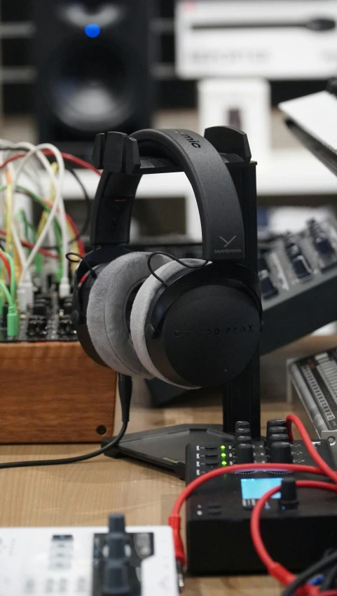 a pair of headphones sitting on top of a desk, by Niels Lergaard, hurufiyya, modular, from valve, pteranadon styling, round-cropped