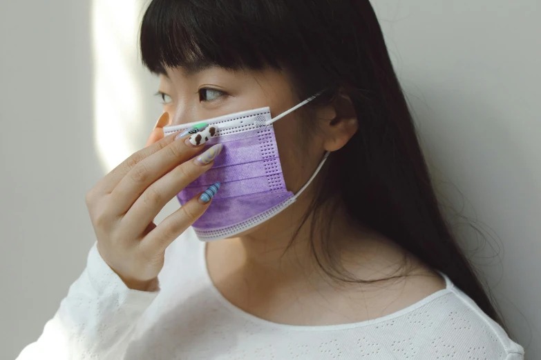 a close up of a person wearing a face mask, trending on pexels, young asian girl, wearing purple undershirt, surgical supplies, hiding