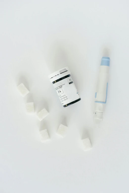 a couple of vials sitting on top of a white table, gum tissue, ultra fine inklines, milk cubes, thumbnail