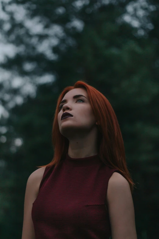a woman with red hair standing in front of trees, inspired by Elsa Bleda, pexels contest winner, young woman looking up, young beautiful amouranth, low quality grainy, dyed hair
