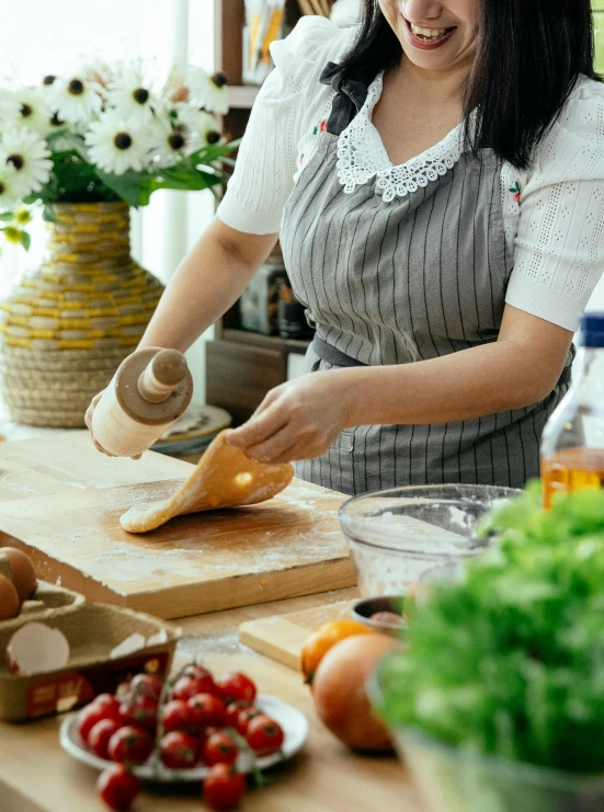 a woman in a kitchen preparing food on a cutting board, by Julia Pishtar, pexels contest winner, square, banner, bakery, graceful curves