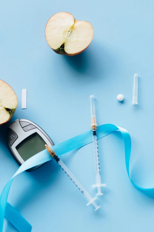 an apple with a measuring tape next to it, a digital rendering, trending on pexels, syringes, blue themed, edible, with a straw