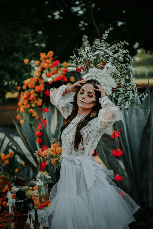 a woman in a white dress posing for a picture, inspired by Frida Kahlo, pexels contest winner, dead plants and flowers, orange halo around her head, soft devil queen madison beer, wedding photo