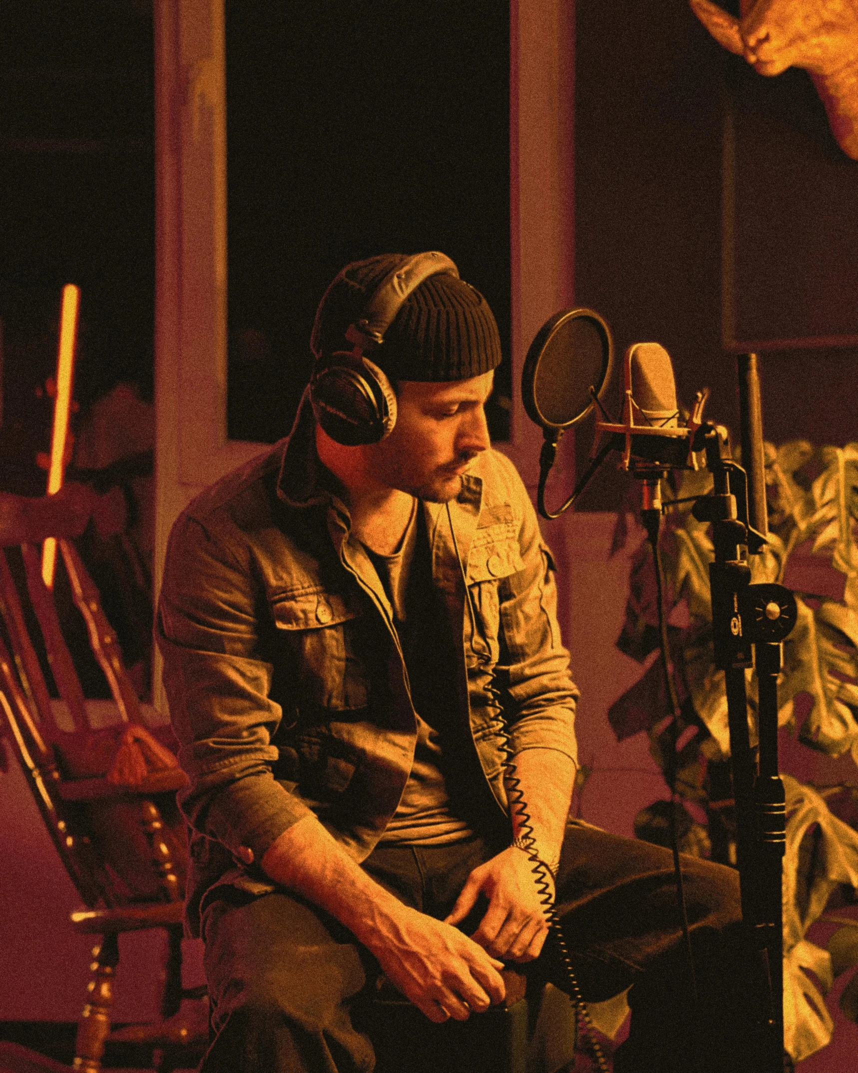 a man sitting in front of a microphone in a recording studio, an album cover, inspired by James Morrison, pexels, process art, lgbtq, backstreet boys, soft light from the side, justin bieber