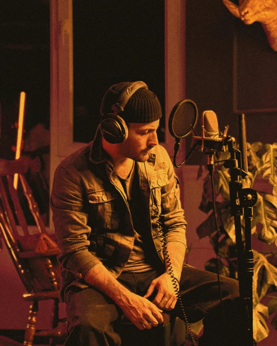 a man sitting in front of a microphone in a recording studio, an album cover, inspired by James Morrison, pexels, process art, lgbtq, backstreet boys, soft light from the side, justin bieber