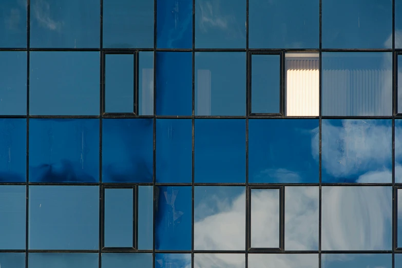 the sky is reflected in the windows of a building, by Jan Rustem, unsplash, modernism, blue metal, square shapes, nadav kander, photograph taken in 2 0 2 0