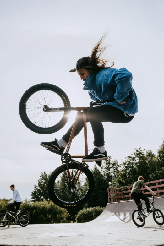 a man flying through the air while riding a bike, a picture, trending on unsplash, realism, woman in streetwear, brown, gnarly, ultra - detailed