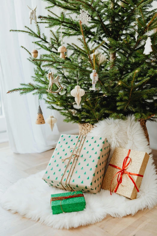 a small christmas tree with presents under it, a portrait, by Julia Pishtar, trending on pexels, hurufiyya, angle view, multiple stories, an elegant green, scandinavian