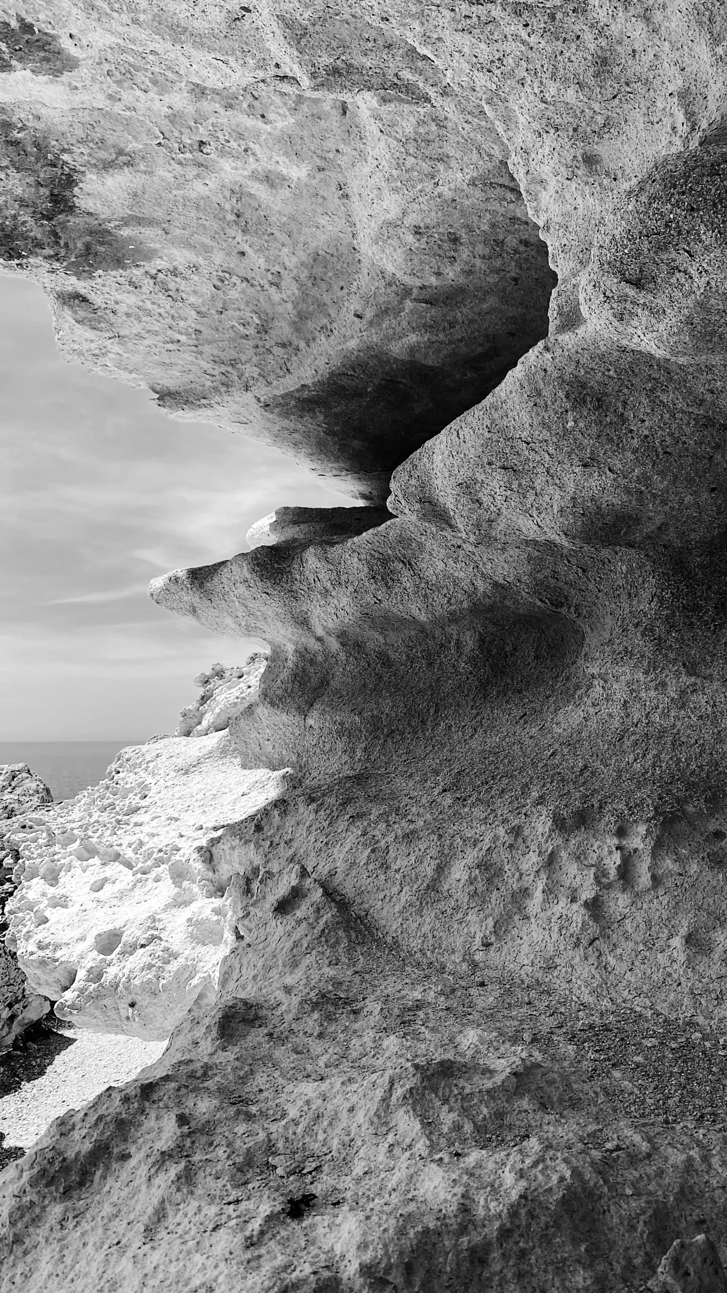 a black and white photo of a rock formation, a black and white photo, inspired by Edward Weston, capri coast, 15081959 21121991 01012000 4k, contours, greek fantasy panorama