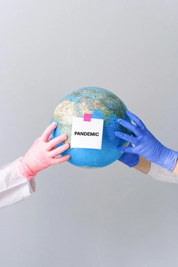 a person in a white lab coat holding a blue globe, an album cover, trending on pexels, happening, hazmat suits, pink, subject action : holding sign, several continents