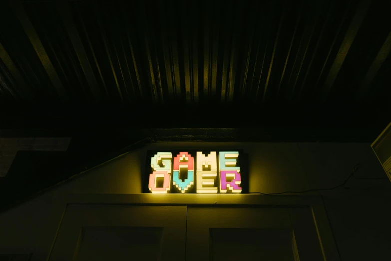a close up of a neon sign above a door, by Joe Bowler, pexels contest winner, inspired in super bomberman, comet, someone lost job, gong