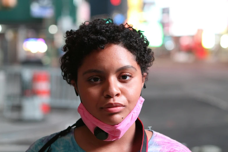 a woman with a pink scarf around her neck, by Meredith Dillman, pexels, renaissance, wearing a stop sign on its head, tessa thompson, humans of new york, at night