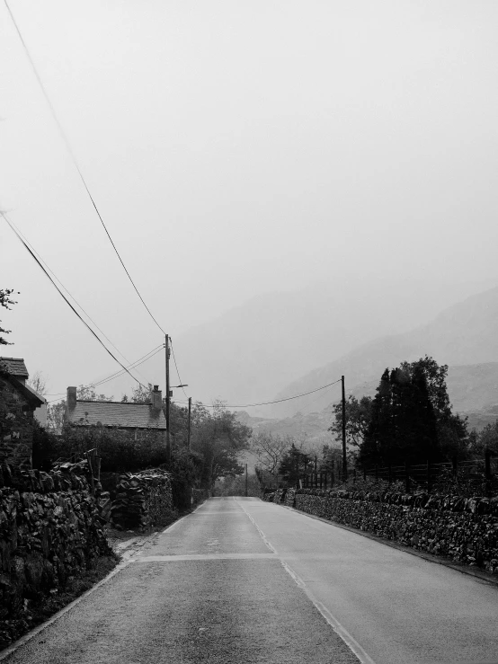 a black and white photo of an empty road, les nabis, atmospheric haze, village, monochrome:-2, stony road