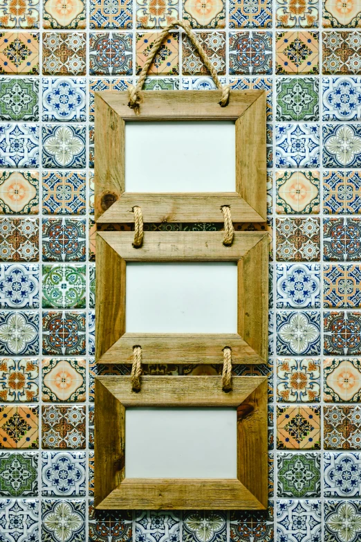 a wooden picture frame hanging on a wall, inspired by Jan Kupecký, tiles, 3 doors, colombian, rack