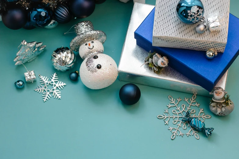 a pile of presents sitting on top of a table, by Julia Pishtar, trending on unsplash, blue and silver, decorative ornaments, teal palette, sanrio ornaments