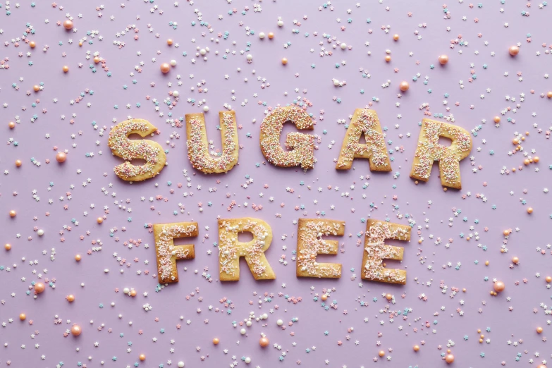 sugar free written in gold letters surrounded by confetti sprinkles, by Nicolette Macnamara, figuration libre, 🥥 🍕 hybrid, carefree, 👰 🏇 ❌ 🍃, recipe