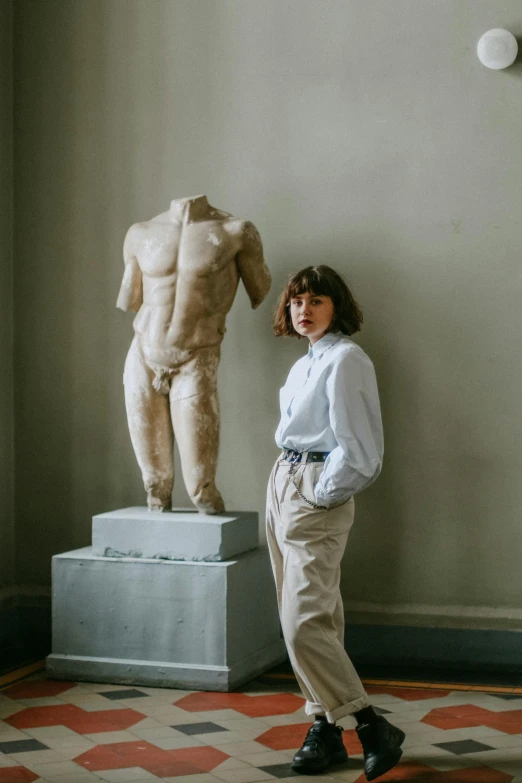 a woman standing in front of a statue, by Nina Hamnett, androgynous male, roman vlasov, trending on art, made of marble