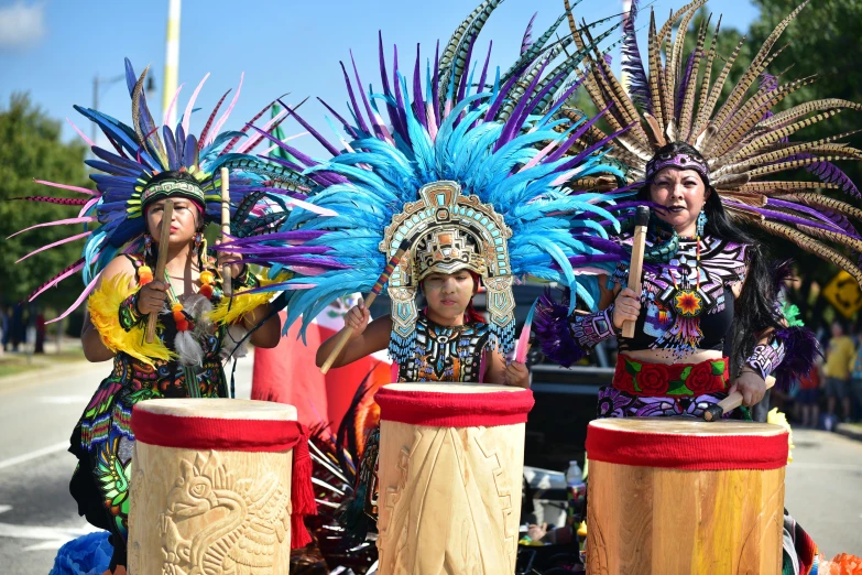 a group of people riding on the back of a truck, pexels contest winner, hurufiyya, danza azteca dancers, avatar image, playing drums, ornate headdress