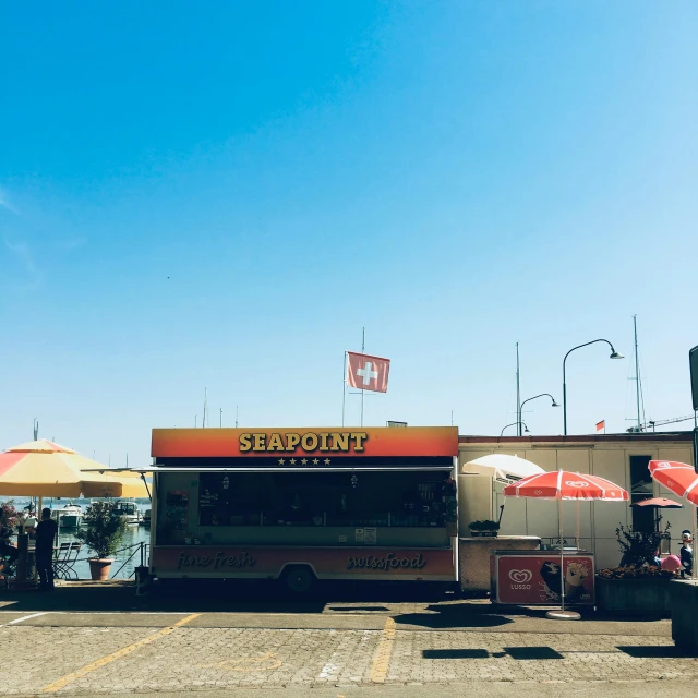 a food truck parked in a parking lot, trending on unsplash, verdadism, viewed from the harbor, stamperia, 🚿🗝📝, bright summer day