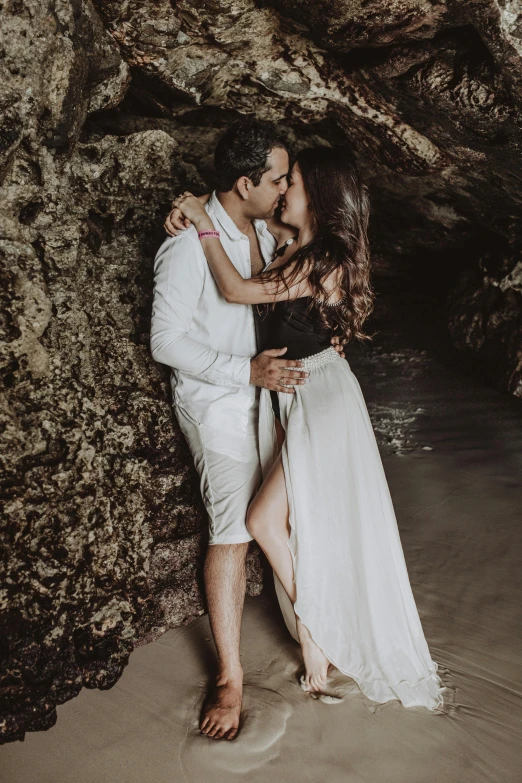 a man and woman standing next to each other on a beach, pexels contest winner, renaissance, in a cave, lovely kiss, upscale photo, cinematic outfit photo