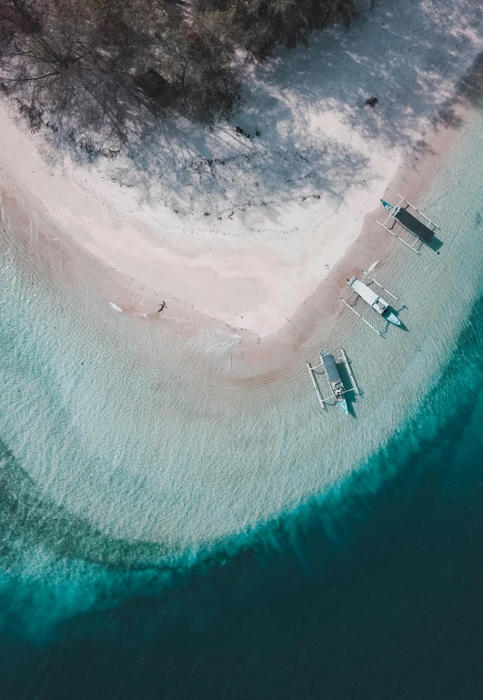 an aerial view of a beach in the middle of the ocean, pexels contest winner, philippines, with water and boats, subtle details, cinematic”