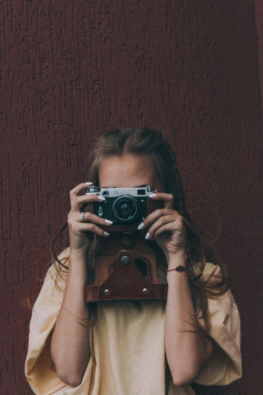 a woman taking a picture with a camera, a picture, inspired by Elsa Bleda, unsplash contest winner, girl with brown hair, vintage muted colors, symmetrical image, trending on vsco