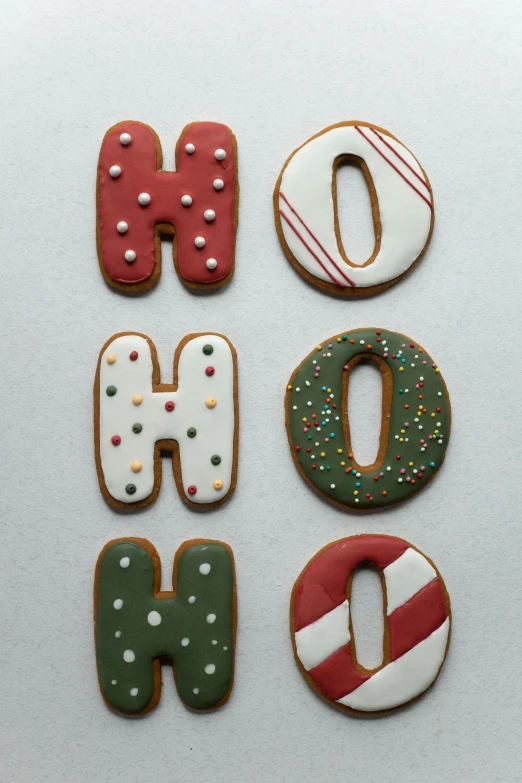 a number of decorated cookies on a white surface, by Sigrid Hjertén, graffiti, hope, ginger, oh no, santa