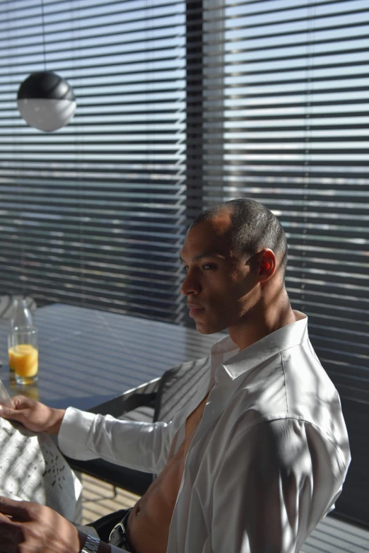 a man sitting at a table with a glass of orange juice, inspired by François Bocion, hyperrealism, vin diesel with a tummy, award winning. cinematic, penthouse, corporate memphis