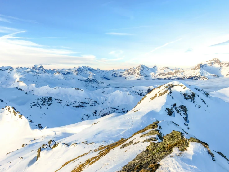 a person standing on top of a snow covered mountain, by Daniel Seghers, pexels contest winner, panoramic view, switzerland, conde nast traveler photo, whistler