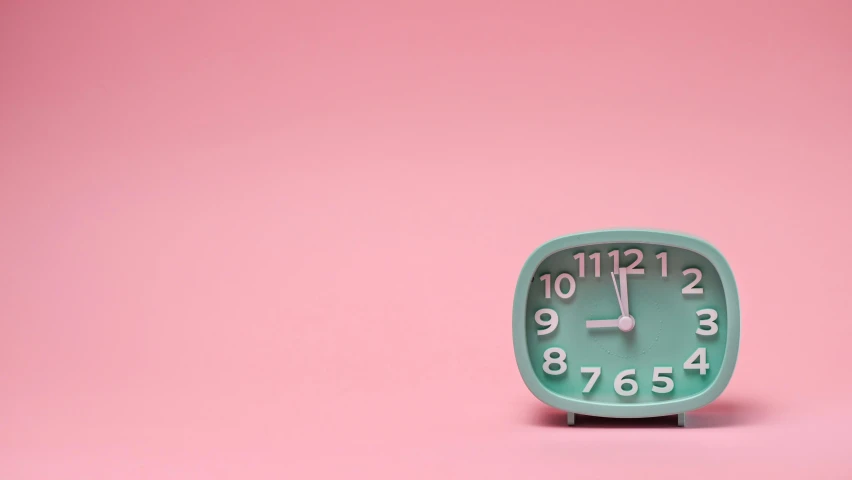 a clock sitting on top of a pink surface, mint, back to the future, clocks, cervix awakening