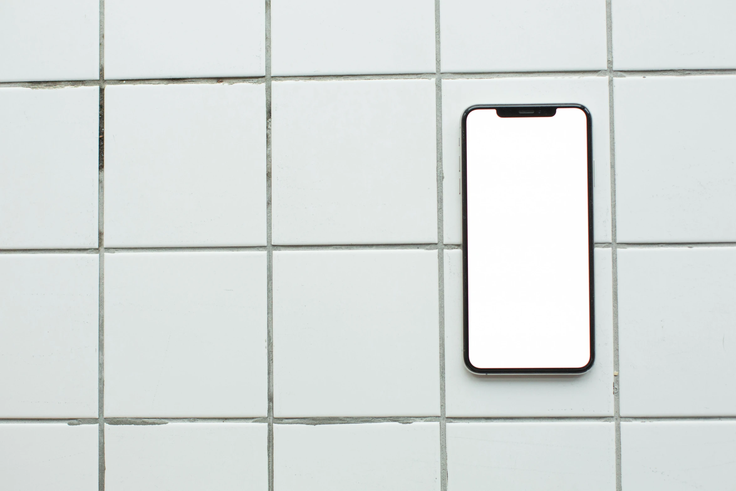 a close up of a cell phone on a tiled wall, by Carey Morris, trending on pexels, bauhaus, clean white background, square, tile floor, thumbnail